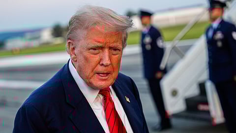 US President Donald Trump speaks with reporters before boarding Air Force One.
