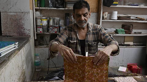 In the dusty corners of Nai Sadak, amid the smells of glue and thread-bound paper, Delhi’s manual binders continue to stitch together the pages of a story that the city is slowly forgetting.