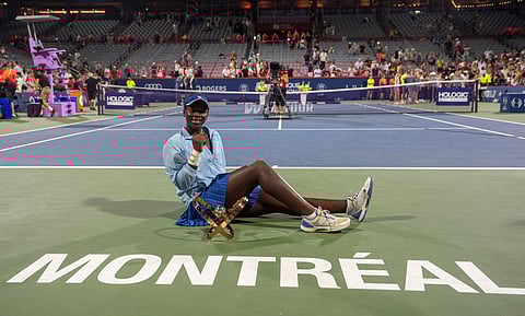 Victoria Mboko, of Canada, poses with the trophy after her win over Naomi Osaka, of Japan, in final action at the National Bank Open women's tennis tournament in Montreal, Thursday, Aug. 7, 2025.