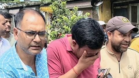 Bhupendra Panwar, owner of a homestay that was washed away in Uttarkashi deluge being consoled by the villagers.