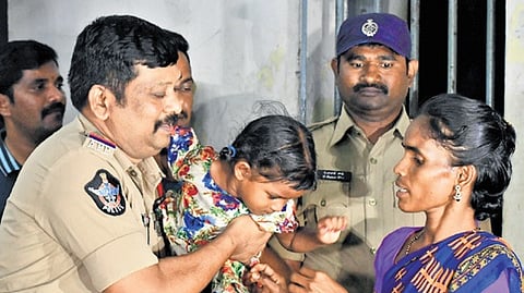 GRP officials hand over the girl to her mother at Vijayawada railway station on Friday.