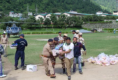 A senior citizen rescued from flood-hit Dharali being brought to ITBP Matli Helipad, in Uttarkashi, Thursday, Aug. 7, 2025.