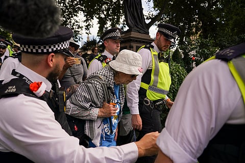 Police officers arrest a demonstrator during a protest in support of the Palestinian People in Gaza, in Parliament Square, in London, Saturday, Aug. 9, 2025.
