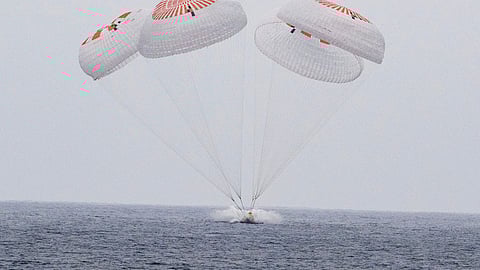 In this image provided by NASA, SpaceX capsule carrying four astronauts, parachutes into the Pacific Ocean off the Southern California coast on Saturday, Aug. 9, 2025.