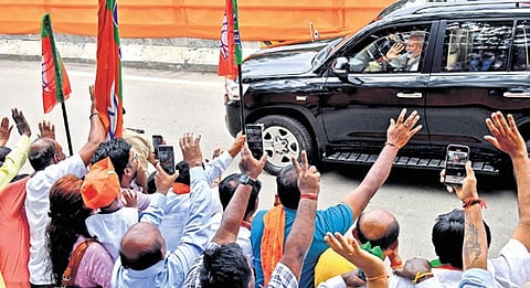 People wave at Prime Minister Narendra Modi at Mehkri Circle in Bengaluru on Sunday ahead of the inauguration of Namma Metro’s Yellow Line; People wait to see the PM at Marenahalli Junction