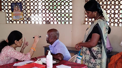 A doctor from Dr VNL Trust, in partnership with Aravind Eye Hospital, examines a patient during a medical camp