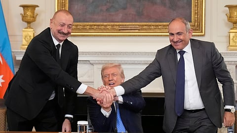 President Donald Trump, center, shakes hands with Armenian Prime Minister Nikol Pashinyan, right, and Azerbaijan President Ilham Aliyev during a trilateral signing ceremony in the State Dining Room of the White House, Friday, Aug. 8, 2025, in Washington.