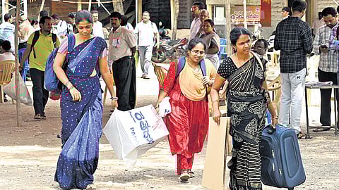 Polling staff leave to their allotted booths with all the election material in Pulivendula on Monday