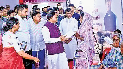 CM Mohan Charan Majhi listening to the problems of a woman at the grievance hearing