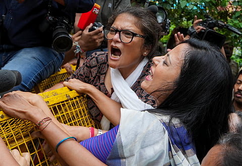 TMC MPs Sushmita Dev and Mahua Moitra with others scale a police barricade during a protest march by INDIA bloc MPs from Makar Dwar of Parliament to the Election Commission of India office over the "poll fraud" issue, in New Delhi, Monday, Aug. 11, 2025