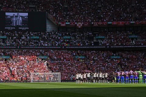 Players stand duringa minute of silence in the memory of Diogo Jota and Andre Silva before the FA Community Shield final soccer match between Liverpool and Crystal Palace at Wembley Stadium in London,Sunday, Aug. 10, 2025.