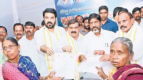 Deputy Chief Minister Mallu Bhatti Vikramarka hands out cheques to scheme beneficiaries in Moinabad, Rangareddy district, on Monday