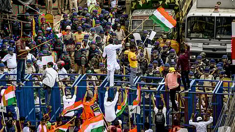 Protestors taking part in a march to the West Bengal secretariat 'Nabanna', to mark the completion of one year of the rape and murder of a trainee doctor at RG Kar hospital, attempt to breach the iron wall barricades set up by the city police.