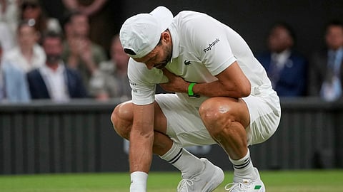 Bulgaria's Grigor Dimitrov clutches his chest with an injury which forced him to retire injured from a fourth round men's singles match against Italy's Jannik Sinner at the Wimbledon Tennis Championships in London, Monday, July 7, 2025.