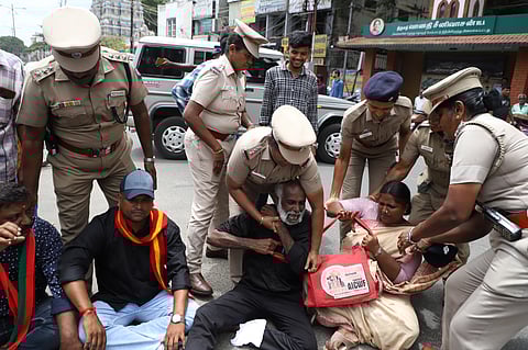 Police detained CCMC sanitary workers attached to trade union as they staged a protest at Town Hall in Coimbatore on Thursday.