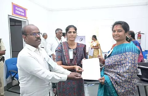 TDP candidate Latha Reddy receiving the certificate of election from the returning officer.