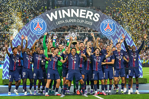 PSG's Marquinhos lifts the trophy with teammates after the UEFA Super Cup soccer match between Paris Saint-Germain and Tottenham Hotspur in Udine, Italy, Wednesday, Aug. 13, 2025.