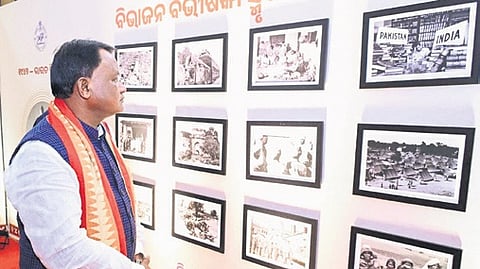 CM Mohan Charan Majhi views pictures during an exhibition held on Partition Horrors Remembrance Day.