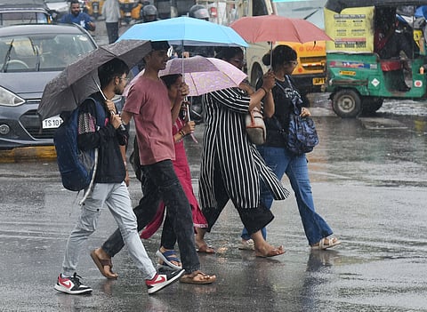 Students were seen reaching their destinations in drizzle while protecting themselves with umbrella in Hyderabad
