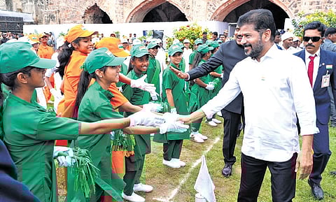 Chief Minister A Revanth Reddy greets schoolchildren during the Independence Day programme at the Golconda Fort