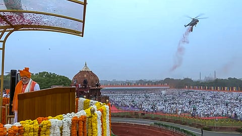 A military helicopter showers flower petals after Prime Minister Narendra Modi hoisted the national flag at the Red Fort on the 79th Independence Day, in New Delhi, Friday, Aug. 15, 2025.