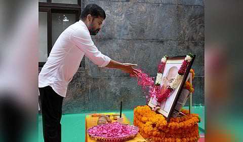 Chief Minister A Revanth Reddy pays floral tributes to the portrait of Mahatma Gandhi at his residence in Hyderabad on Friday