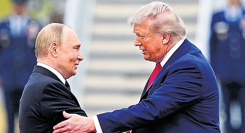 Smoke bellows in the background at dusk in Kyiv, Ukraine, Tuesday, Oct. 21, 2025.