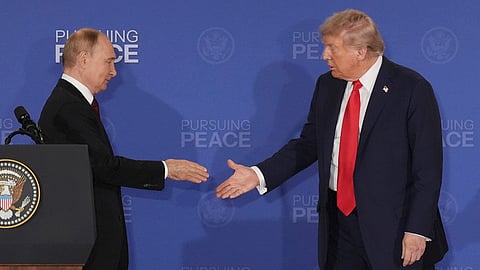 President Donald Trump, right, walks to shake the hand of Russia's President Vladimir Putin during a joint press conference at Joint Base Elmendorf-Richardson, Alaska, Friday, Aug. 15, 2025.