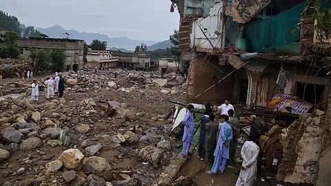 Local residents look at damaged homes and buildings following Friday's flash flooding at Pishoreen village in Buner district, in Pakistan's northwest, Sunday, Aug. 17, 2025.