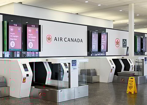 An empty Air Canada bag drop area is shown as Air Canada flight attendants strike at Montreal–Trudeau International Airport in Montreal, Saturday, Aug. 16, 2025.