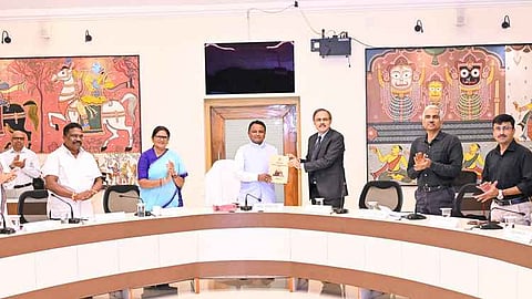 CM Mohan Majhi receiving interim report of the 6th State Finance Commission chairman Arun Panda.