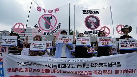 South Korean protesters stage a rally to oppose the joint military exercises, Ulchi Freedom Shield or UFS, between the U.S. and South Korea in front of the presidential office in Seoul, South Korea, Monday, Aug. 18, 2025.