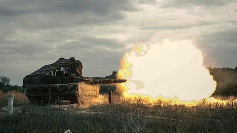 In this photo taken and distributed by Russian Defense Ministry Press Service on Friday, Aug. 15, 2025, a Russian tank fires during a practice at a training ground during on an undisclosed location in Ukraine.