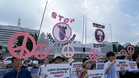 South Korean protesters stage a rally to oppose the joint military exercises, Ulchi Freedom Shield or UFS, between the U.S. and South Korea in front of the presidential office in Seoul, South Korea, Monday, Aug. 18, 2025.