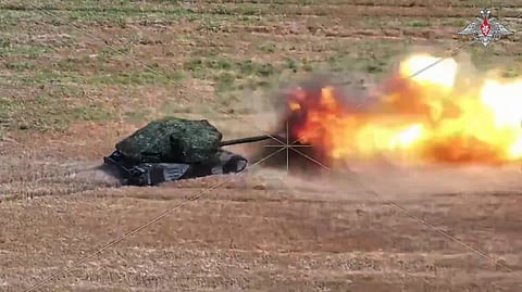 In this photo taken from video distributed by Russian Defense Ministry Press Service on Tuesday, Aug. 19, 2025, a Russian T-80BVM tank fires towards Ukrainian positions in an undisclosed location in Ukraine.