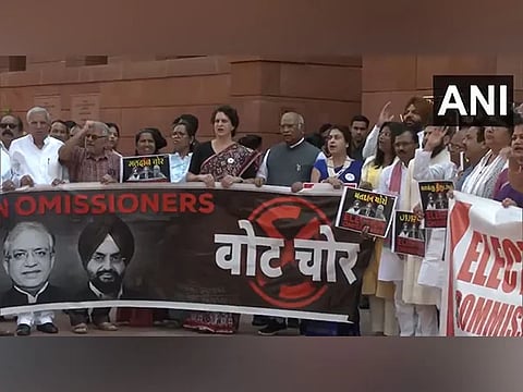 INDIA Bloc protest against "vote theft" allegations, SIR outside parliament building.