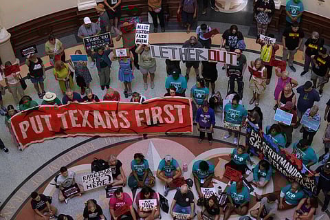 Protesters gather in the rotunda outside the House Chamber at the Texas Capitol as lawmakers debate a redrawn U.S. congressional map in Texas during a special session, Wednesday, Aug. 20, 2025, in Austin, Texas.