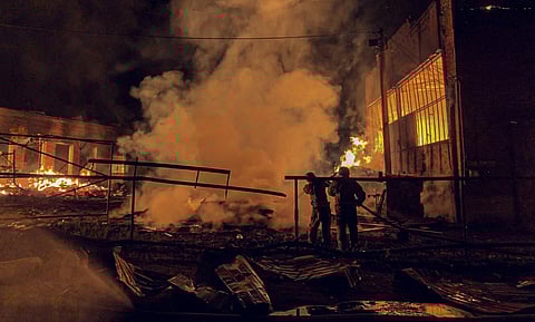 This handout photograph taken and released by the Ukrainian Emergency Service on August 20, 2025, shows Ukrainian emergency workers in action following an air attack, in Okhtyrka, Sumy region, amid the Russian invasion of Ukraine.