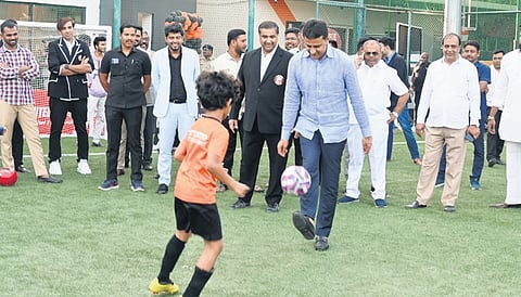MLA Rizwan Arshad tackles a football at the event on Thursday