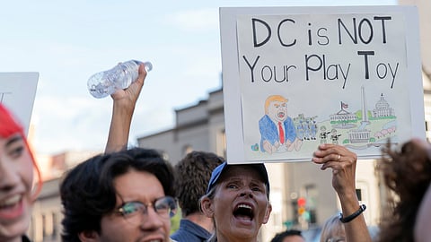 People rally against President Donald Trump's use of federal law enforcement and National Guard troops along the U street corridor in northwest Washington Thursday, Aug. 21, 2025.