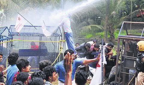 Police fire water cannons during the protest march by SFI to the office of MLA Rahul Mankoottathil in Palakkad on Friday