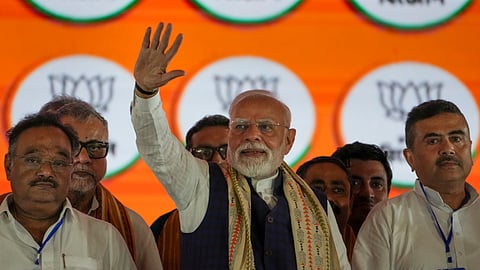 Prime Minister Narendra Modi with West Bengal BJP President Samik Bhattacharya and LoP in the West Bengal Assembly and BJP leader Suvendu Adhikari during a public meeting in Kolkata, Friday, Aug. 22, 2025.
