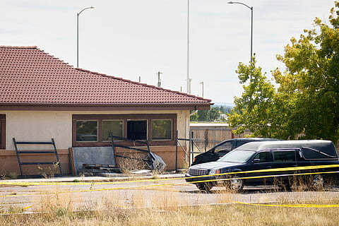 A hearse and van sit outside the Return to Nature Funeral Home in Penrose, Colo., on Oct. 6, 2023.