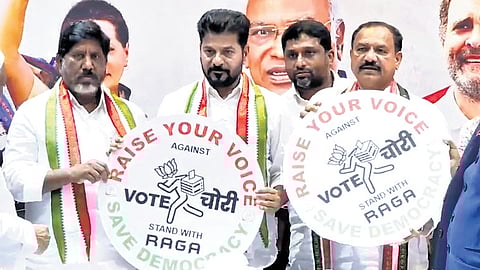 Chief Minister A Revanth Reddy releases a ‘Vote Chori’ poster during the PAC meeting at Gandhi Bhavan in Hyderabad on Saturday