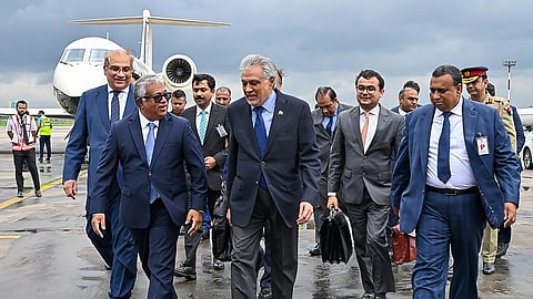 This handout photograph taken and released by Bangladesh's Ministry of Foreign Affairs on August 23, 2025, shows Bangladesh's Foreign Secretary Asad Alam Siam (L) receiving Ishaq Dar (2L), Pakistan's Foreign Minister, at the Hazrat Shahjalal International Airport in Dhaka.