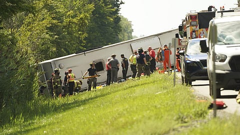 First responders work to rescue victims at the scene of a tour bus that crashed and rolled over on the New York State Thruway near Pembroke on August 22, 2025.