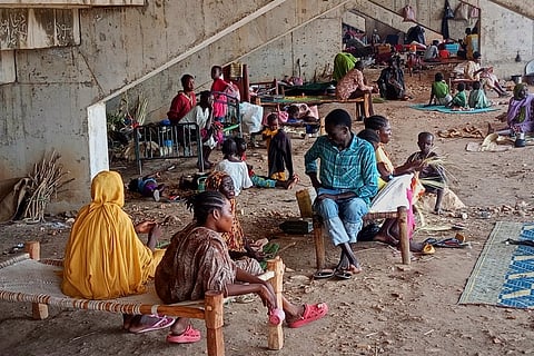 In this photo released by the NGO Mercy Corps, Sudanese families displaced by RSF attacks in Kordofan take shelter in a football stadium.