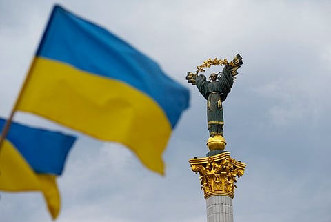The Independence Monument is pictured as Ukrainian flags blow in the wind in Kyiv, Ukraine, on Saturday, Aug. 23, 2025.