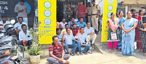 Customers protest at the Chennur branch of SBI in Mancherial district on Monday