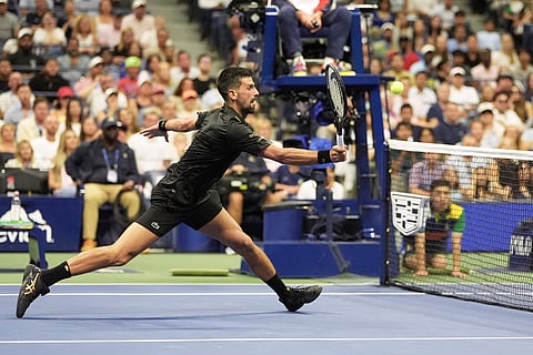 Novak Djokovic, of Serbia, returns a shot to Learner Tien, of the United States, during the first-round of the U.S. Open tennis championships, Sunday, Aug. 24, 2025, in New York.
